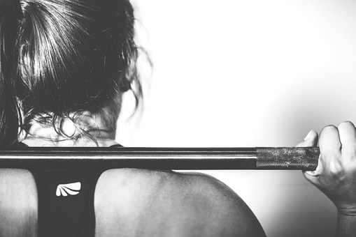 image of woman using barbell